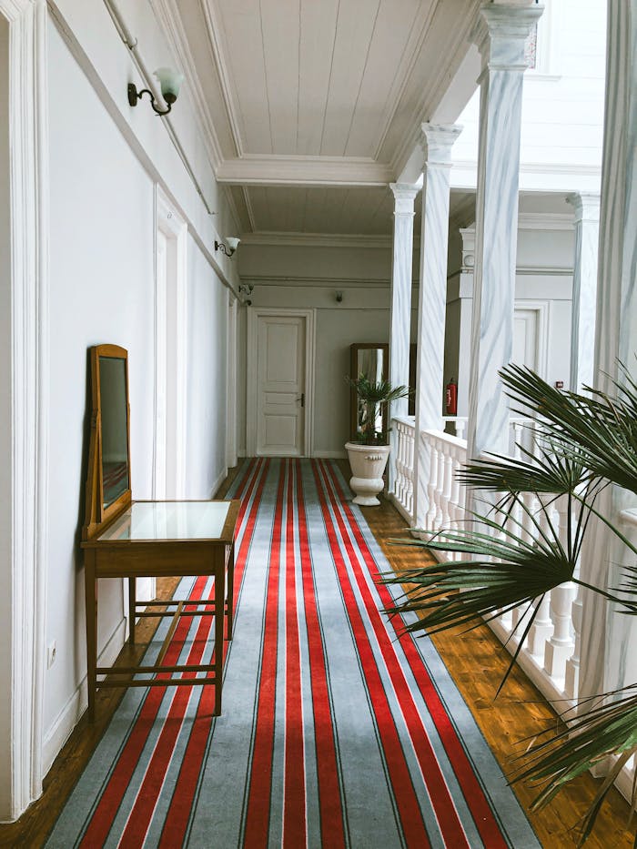 Stylish indoor corridor with columns and vibrant carpet in Büyükada, İstanbul.